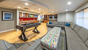 A modern living room with a foosball table, a sofa, and a colorful ottoman. - Marriott's Timber Lodge - Ski-In & Ski-Out - Sleeps 8! (South Lake Tahoe)