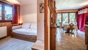 A room with a bed, a dining table with chairs, a view of the outdoors, and a wooden ceiling. - T3 Chatel Apartment with Mountain View, Private Terrace and Balcony (chatel)