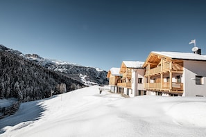 A snow-covered mountain landscape with wooden cabins.