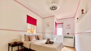 A bedroom with a bed, a nightstand, a dresser, and a window with a red curtain. - Vacation Home 'Vitamina Village' with Sea View, Shared Pool, Garden & Wi-Fi (Adeje)