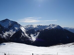 A snow-covered mountain landscape with clear skies.