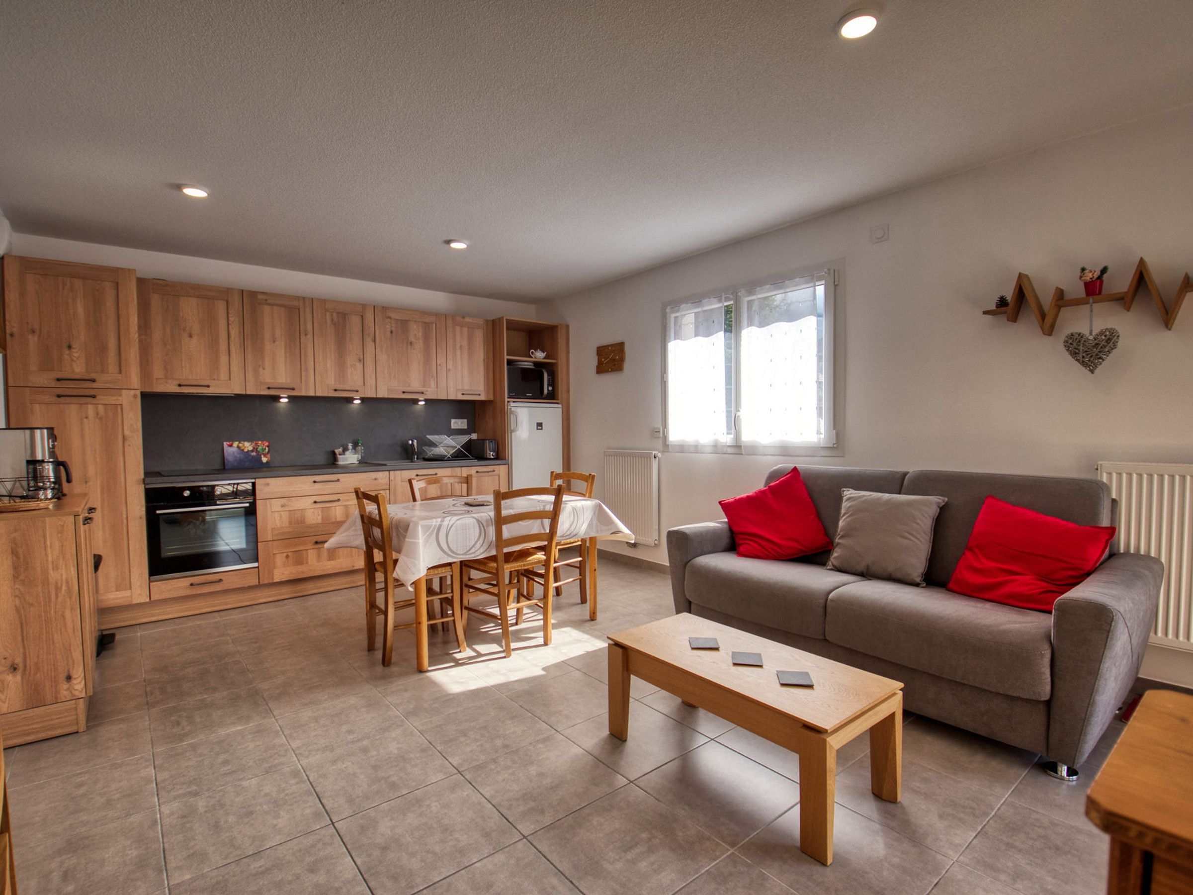 A compact living space with a kitchenette, dining area, and seating area.