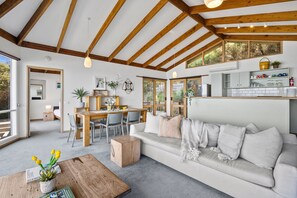 A modern interior with a dining area, sofa, and kitchen. - Pelican Views - Fairhaven (Fairhaven)