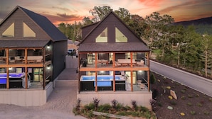 A two-story building with a balcony and a pool area. - Heated Private Pool, Lake view, No steps | Mini Thistle (Hollister)