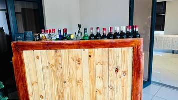 A wooden bar counter with various bottles of alcohol.