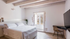 A bedroom with a bed, a desk, and a television. - Giudecca's Studio with Terrace by Wonderful Italy (Siracusa)