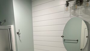 A bathroom with a toilet, sink, and mirror. - “Truly Beautiful”.    Golf Course & Lake View Getaway – Minutes from the Beach! (Pawleys Island)