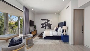 Ein modernes Schlafzimmer mit Bett, Nachttisch und einem großen Fenster.