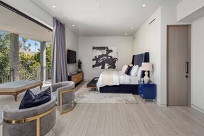 Une chambre à coucher moderne avec un lit, une table de chevet et une grande fenêtre.