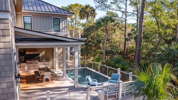 A house with a deck, outdoor kitchen, and a swimming pool. - Stunning Coastal Gem in Vanderhorst with private pool (Kiawah Island)