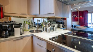 A modern kitchen with a built-in stove, a sink, and various appliances.