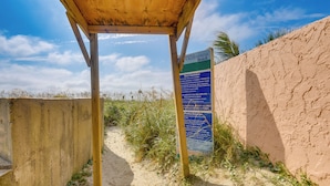 A beach path with a wooden shelter and a signboard. - Pool Access: 8th-floor Condo on North Myrtle Beach (North Myrtle Beach)