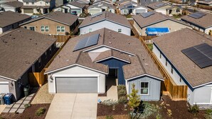 A residential area with multiple houses, each featuring a garage and solar panels on the roofs. - Pet-friendly Merced Vacation Rental! (Merced)