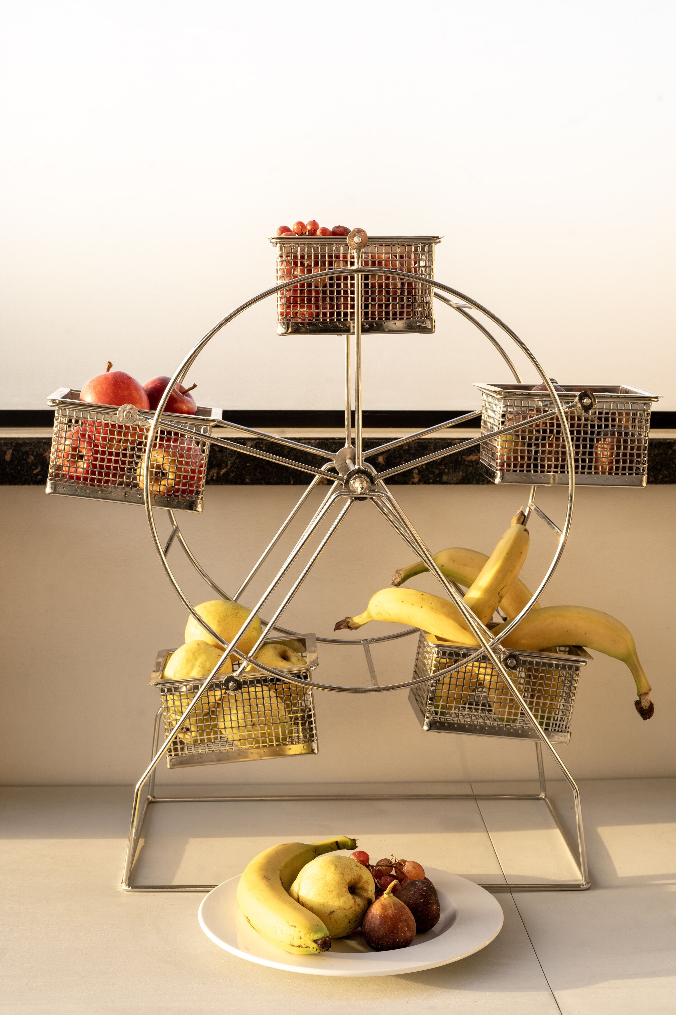 A fruit stand with bananas, apples, and pears.