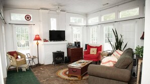 A cozy living room with a fireplace, a television, and comfortable seating.