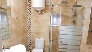 A bathroom with a shower, toilet, and sink. - Galiello & Bacco by CorfuEscapes (Corfu)