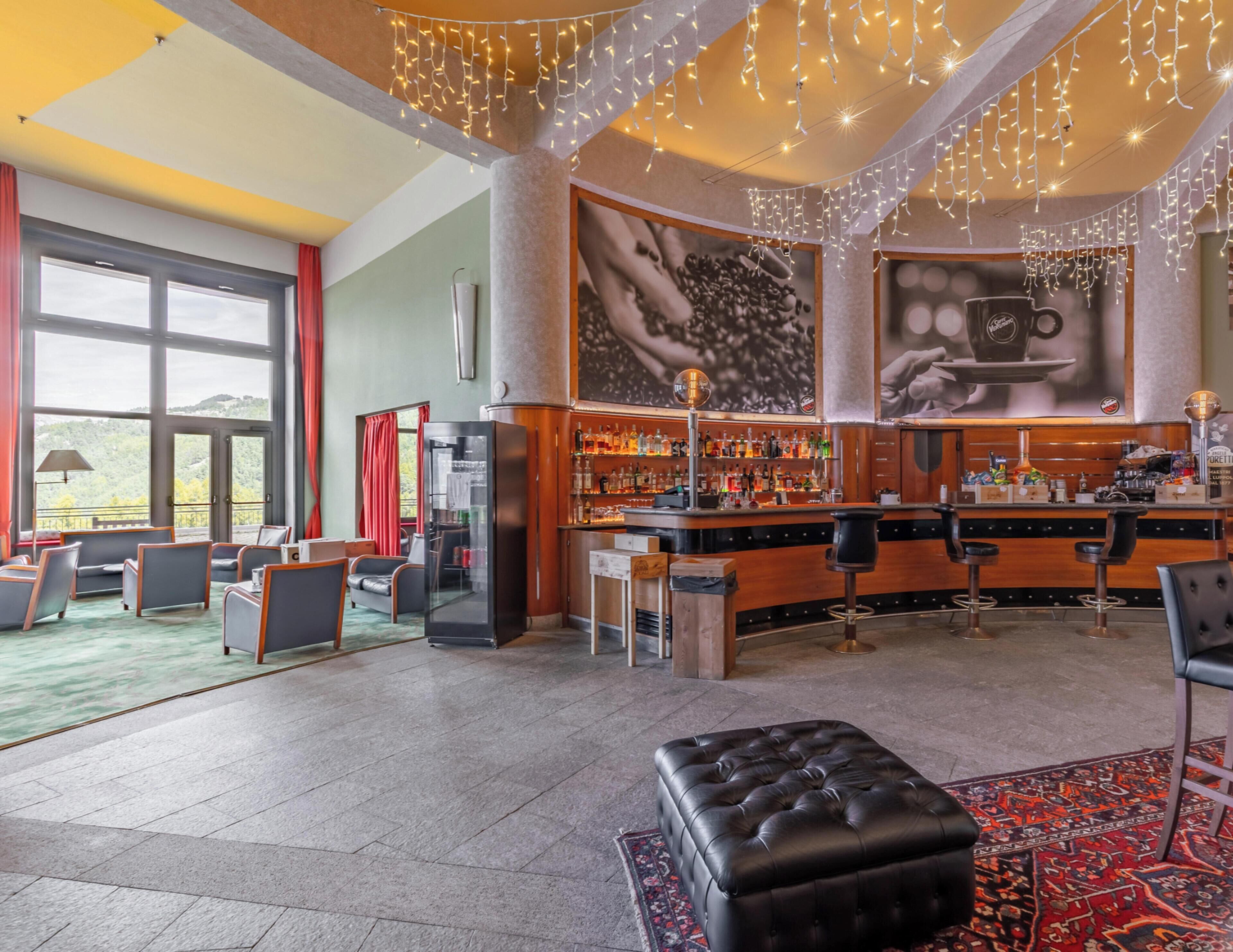 A bar area with a counter, stools, and a large coffee cup mural.