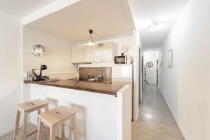 Fridge, microwave, coffee/tea maker, cookware/dishes/utensils