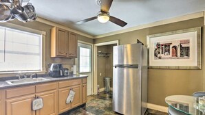 A kitchen with a stainless steel refrigerator, a coffee maker, and a window with blinds. - New!Quaint & Convenient Hideaway: Great Location (East Hartford)