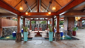 A covered outdoor seating area with stone walls, wooden beams, and hanging lights. - Hanalei Bay Resort-A/C, Beach, Bali Hai Views from 3 Lanai's, Washer & Dryer (Princeville)