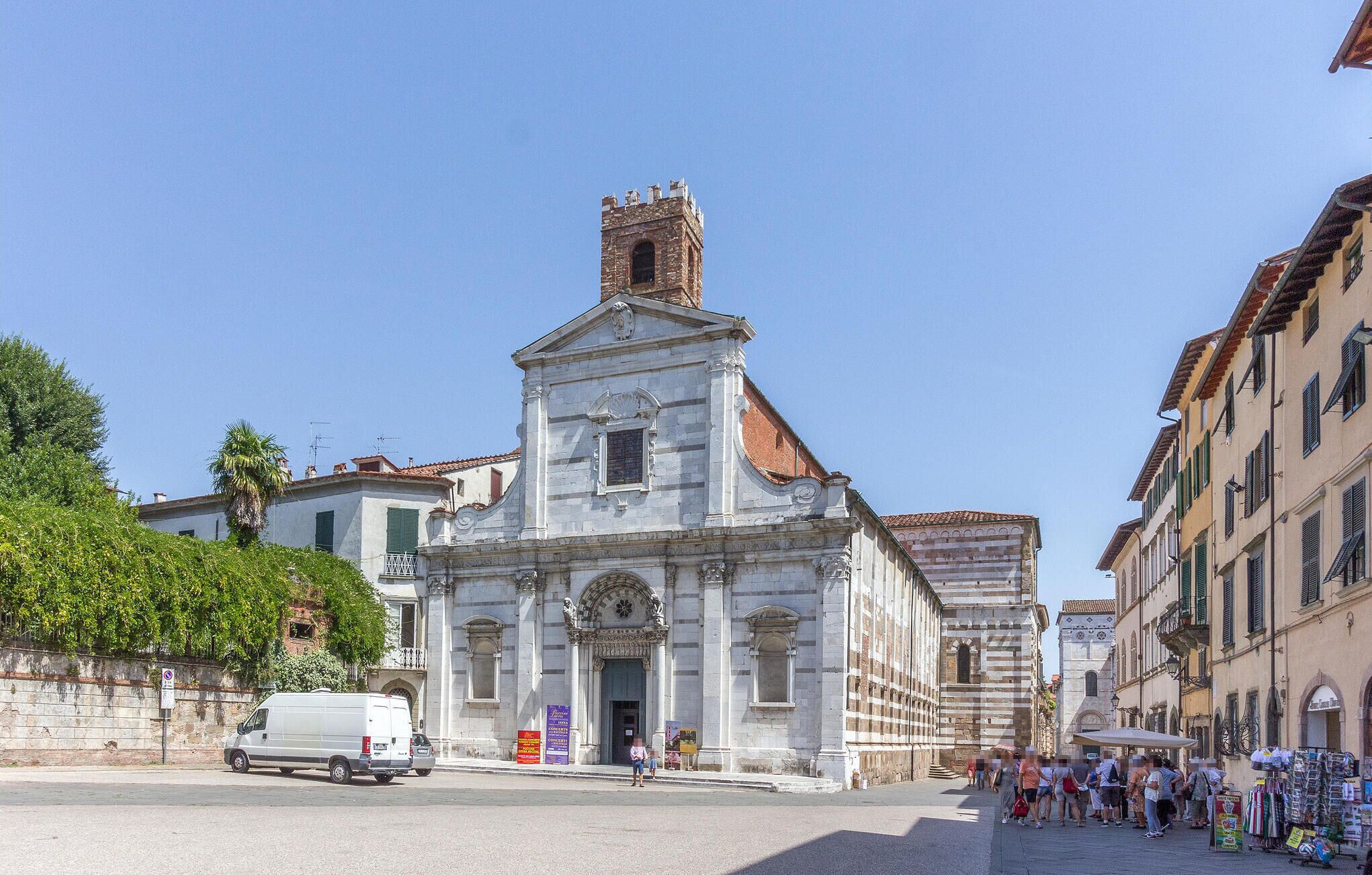 A historic church with a prominent bell tower and a central entrance.