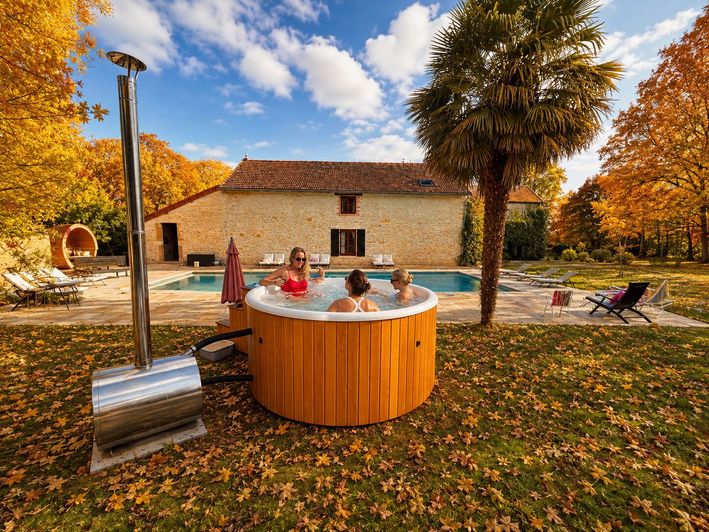 A hot tub in a garden with a stone building in the background.