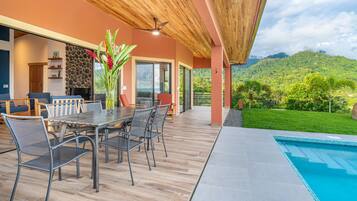 Enjoy al fresco dining with a view of the lush landscape and hills beyond.