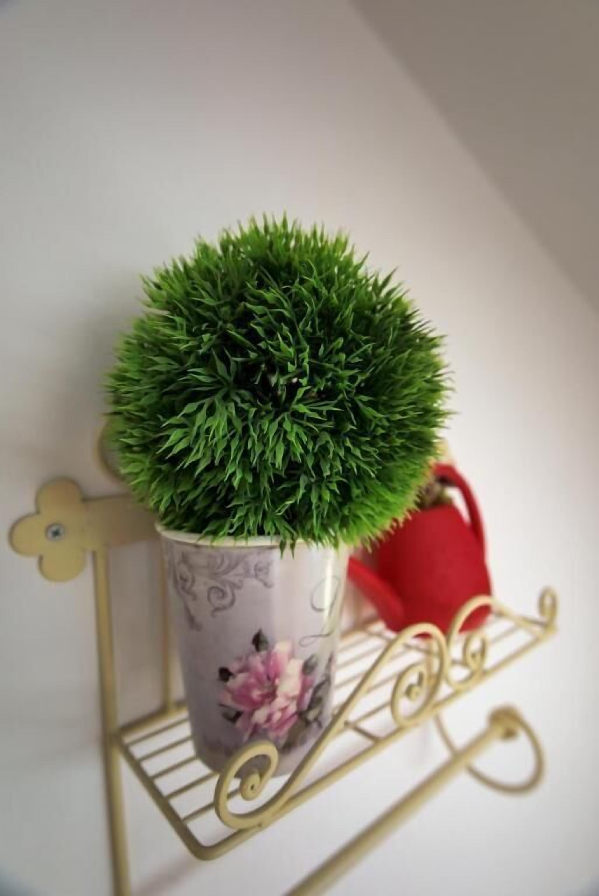 A potted plant on a decorative metal stand.