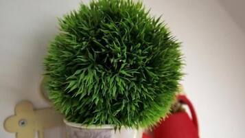 A potted plant on a decorative metal stand.
