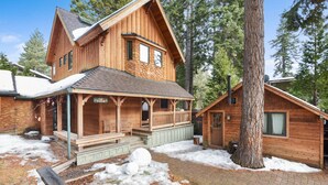 A wooden cabin with a porch, a covered deck, and a chimney. - Lodgepole Lair - Remodeled, Walkable, Lake & Ski (Tahoe City)