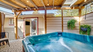 A hot tub under a wooden pergola with hanging lights, surrounded by wooden walls and potted plants. - Hot Tub, 5 Mi to Dtwn! Newly Updated Seattle Home (Seattle)