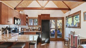 Una cocina amplia con armarios de madera, una isla grande y vistas a una terraza.