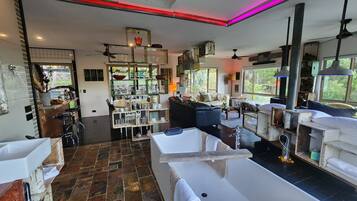 A spacious living area with a large window, a fireplace, and a dining area with bar stools.