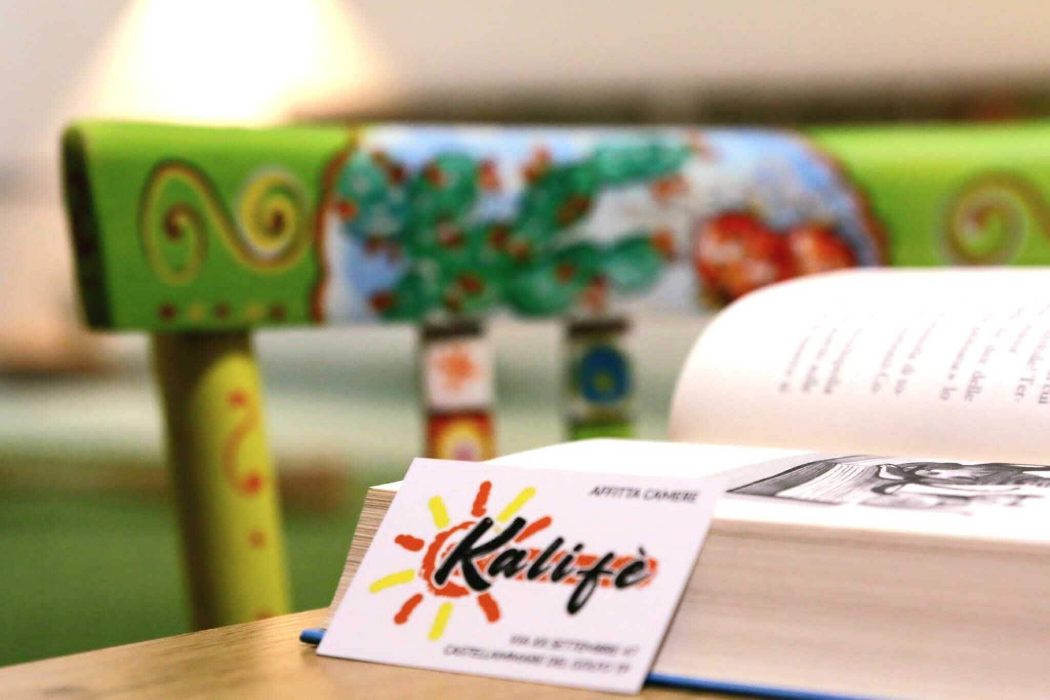 A book with a colorful cover and a name tag on a wooden surface.