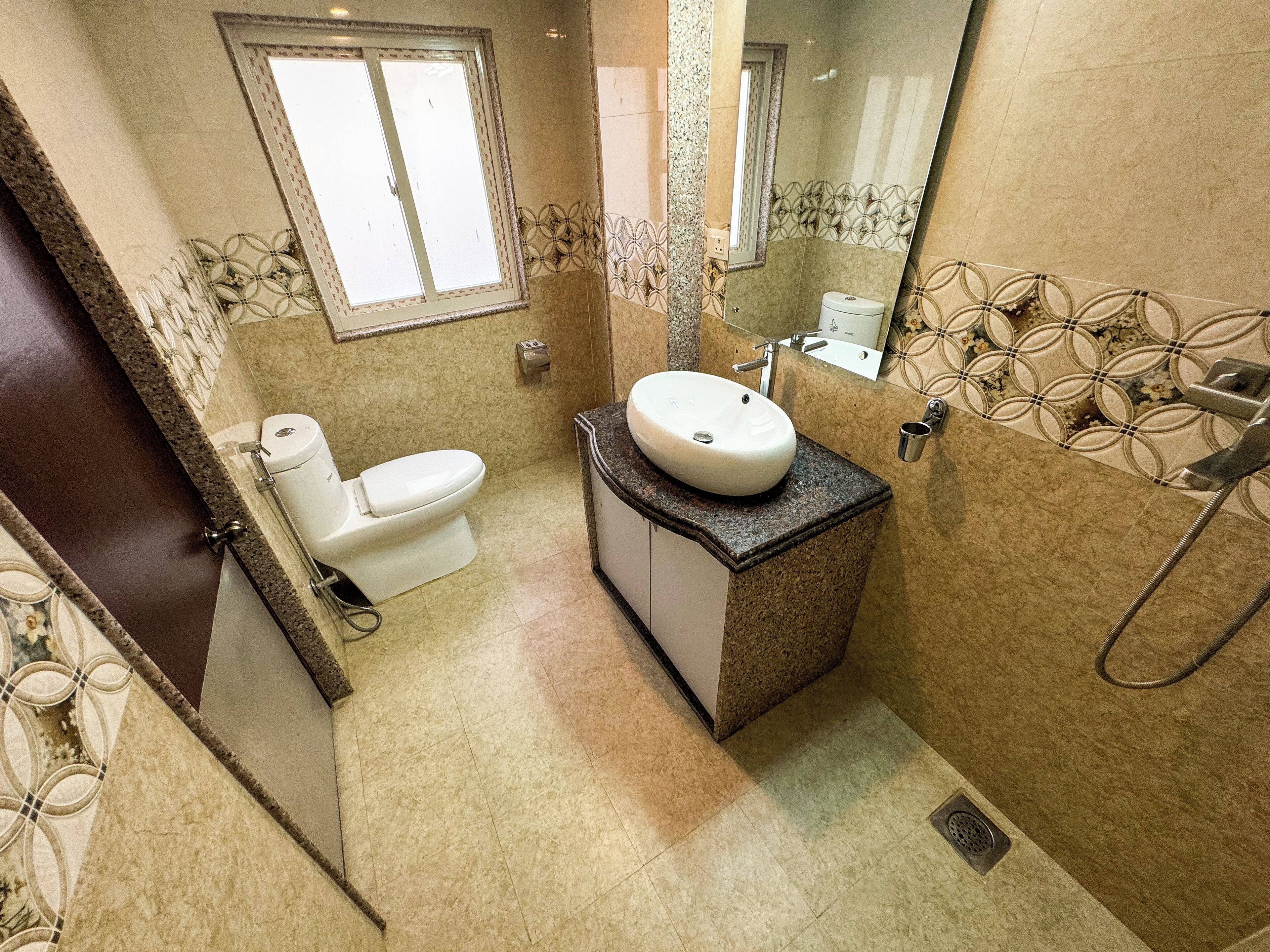 A bathroom with a toilet, sink, and shower.