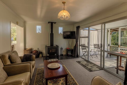   Amongst trees is this quaint cottage & within a 5-minute walk to town & beach 