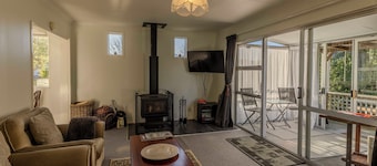   Amongst trees is this quaint cottage & within a 5-minute walk to town & beach 