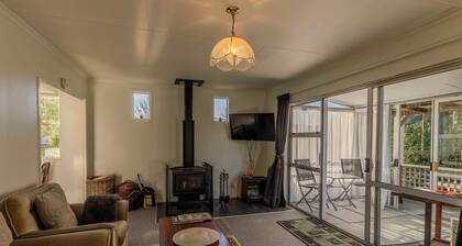 Amongst trees is this quaint cottage & within a 5-minute walk to town & beach