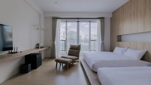 A modern hotel room with a large bed, a chair, a TV, and a window with curtains. - terumahouse (Taitung)