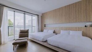 A modern hotel room with two beds, a large window, and a view of the outdoors. - terumahouse (Taitung)