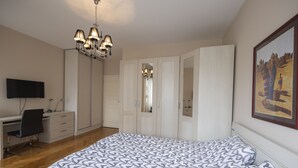 A bedroom with a bed, a desk, a chair, a TV, and a wardrobe. - Belgrade Center Apartment  Lux II (Belgrade)