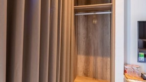 A modern closet with wooden shelves and a built-in step ladder. - My My Hotel 2 (Ho Chi Minh City)