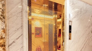 A marble-floored hallway leading to a room with a glass door. - My My Hotel 2 (Ho Chi Minh City)