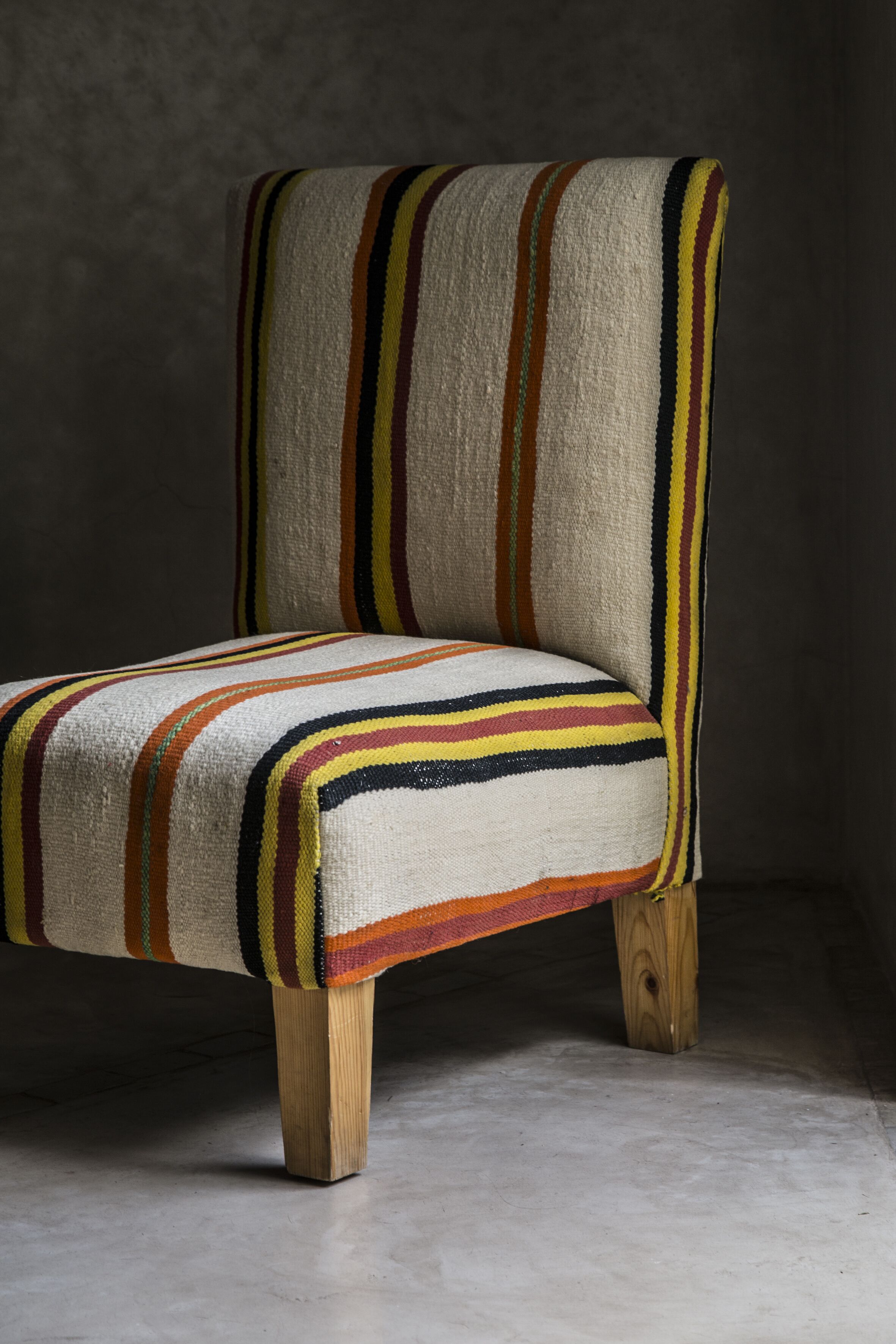 A chair with a striped fabric design.