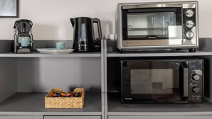 A kitchenette with a Philips coffee maker, a Toshiba microwave, and a toaster oven on a countertop. - Le Dimore del Corso Acireale II Sicily Stay near Catania Taormina, the Sea, Etna (Acireale)