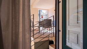 A staircase leading to a dining area with a table and chairs. - Le Dimore del Corso Acireale II Sicily Stay near Catania Taormina, the Sea, Etna (Acireale)