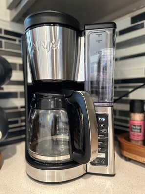 A Ninja coffee maker with a digital display, placed on a kitchen counter. - Iconic Downtown Athens Condo I Sanford Stadium View I 10 Min Walk to Games (Athens)