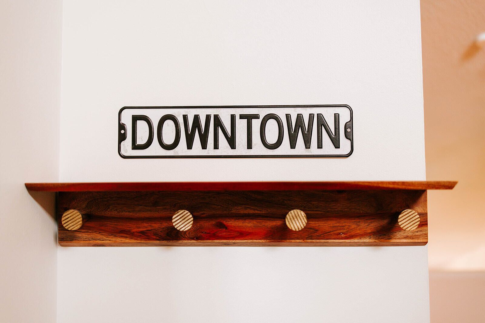 A sign with the word 'DOWNTOWN' on a white background.