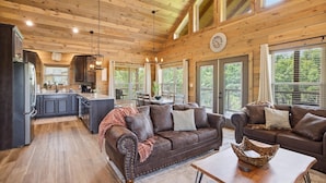 Een ruime cabin met keuken, eethoek en zithoek.
