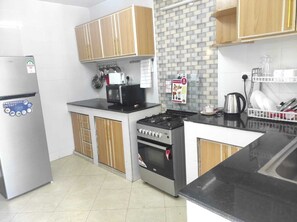 Fridge, microwave, toaster, dining tables